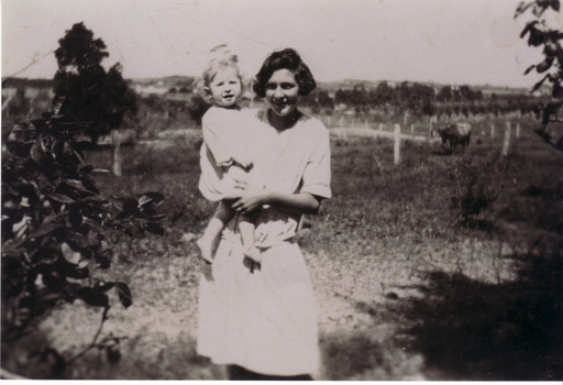 Black and white photograph of Dorothy Penn holding baby harold on property in Orchard Grove, Blackburn South.