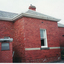 Coloured  photograph of the side view of the original home of Mr. Edward and Mrs. Mary Pearce built in 1870s. 