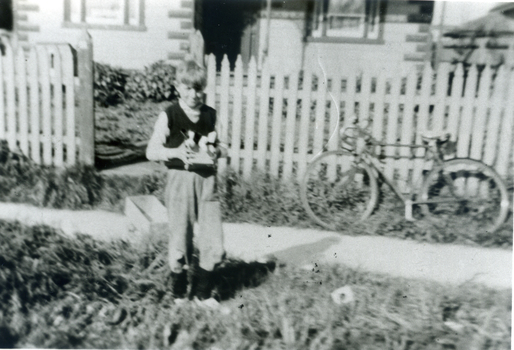 Black & white photo of Vern Osterlund outside family home near corner of Albert Street And Whitehorse Road, Mitcham. 