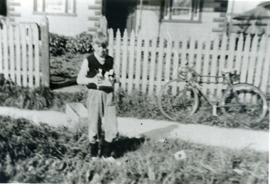 Black & white photo of Vern Osterlund outside family home near corner of Albert Street And Whitehorse Road, Mitcham. 