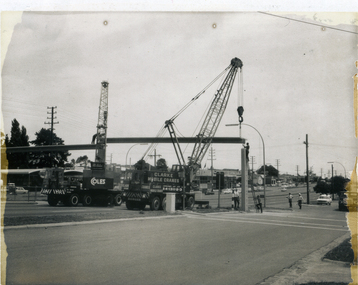 Placing spans for pedestrian overpass in position. Whitehorse Road and Peel Street intersection, Mitcham