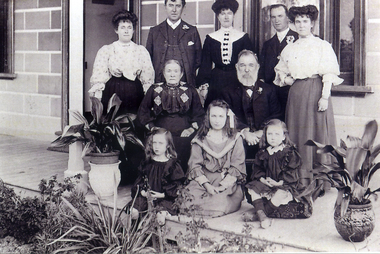 Jane and John McDonnell and family members on the verandah of their home at 42 McDowall Street Mitcham.