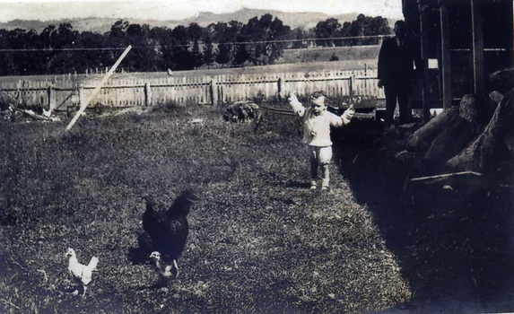 View of the back of the Reserve Hotel, Mitcham, owned by John McDonnell. Railway line in background. Man and child unknown. c1900