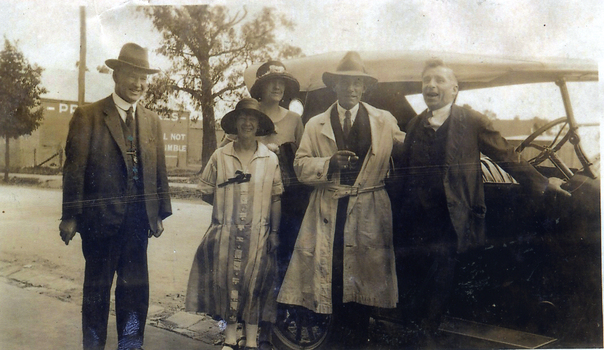 Michael (Mick) McDonnell with friends (unknown) by a car in Mitcham. 