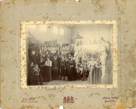  c 1910  the inside of Mitcham Scout Hall during a Methodist Bazaar. Large group of people including D. Walker, R and F Barelli, Mrs  E.E. Walker and Mr E.E. Walker