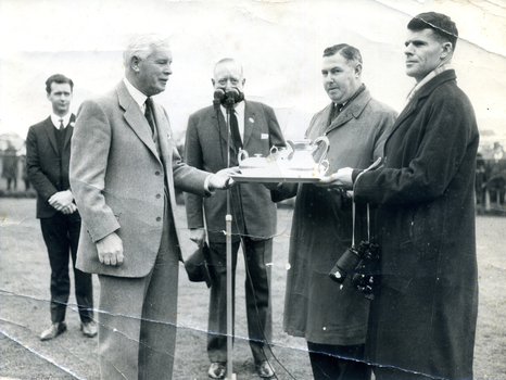 Geoff Peck, son of Tally Ho orchardist Ronald Peck, receiving a trophy for winning the Grand National Hurdle at Flemington in 1967.