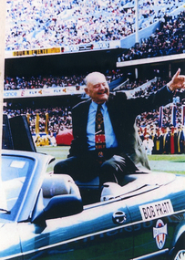Bob Pratt circling the MCG in a car