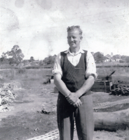 ohn Williams of East Doncaster Road, Mitcham, standing in front of the Mitcham Reservoir construction site in c1922