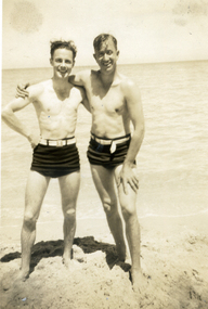 Two men in bathers on beach during the St Luke's Anglican Church Sunday school Teachers' picnic at Seaford in 1947.