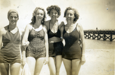 Four young women in bathers on the beach during the St Luke's Anglican Church Sunday School Teachers' picnic at Seaford in 1947.