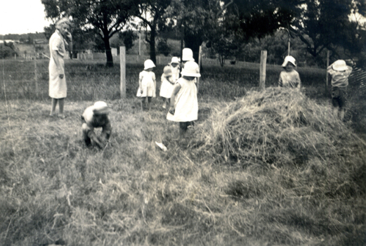  Children helping with haymaking at the Forest Hill Residential Kindergarten.