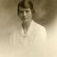 Studio postcard photograph of Evelyn Maggs in a white dress. Dated 1919.