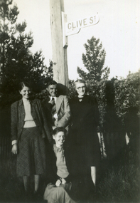 Group of four people in front of a sign post 'Clive Street'.