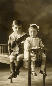 Alwyn and Alison Till on a wooden piano stool Inscription