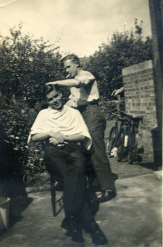 Man cutting Alwyn Till's hair.