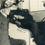 Alwyn Till and Tom Mildred in airforce uniform wearing fireman's helmets. 