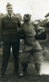 Alwyn Till standing next to a person in an inflated flying suit.