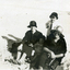 Two women and two children on a beach. 