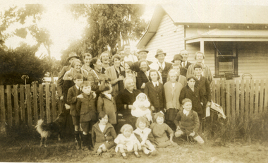 A large group of men, women, children and a dog