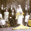  A 1st May 1913 wedding party. Three men, two flower girls, bride standing, 