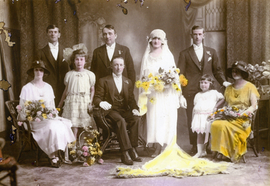  A 1st May 1913 wedding party. Three men, two flower girls, bride standing, 