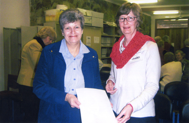 Coloured Photograph of mayor (2009) Helen Harris, and W.H.S. president, Vicki Jones-Evans standing in the W.H.S. workroom,