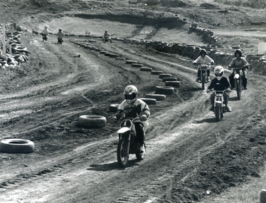 Motocross track near the waste transfer station at Vermont South. Motorcyclist in centre of photograph with three following. 1994