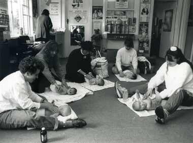 Photograph taken in the Mitcham Maternal and Child Care Centre of a group of five women learning the art of baby massag