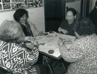 Four female members of the Indo-Chinese Association playing a traditional game.  1994.