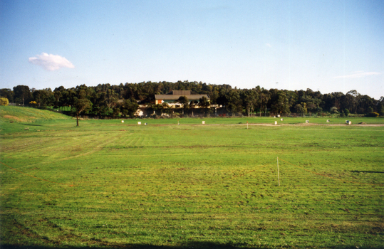 Early days in the development of the Morack Golf Course. Overview of a hole plus white patches indicating where trees have been planted.