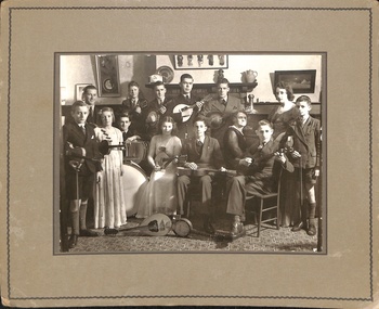 Mounted photograph of a musical group, with instruments, in the vicarage of Christ Church, Anglican Church, Mitcham. 