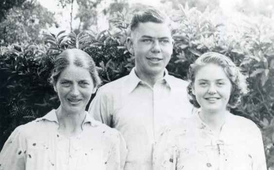 Evelyn Till and her children, Alwyn and Alison.Outdoors, hedge behind