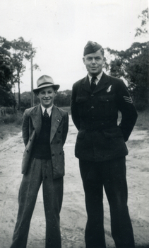 Two men standing with their hands behind their backs [at ease position]