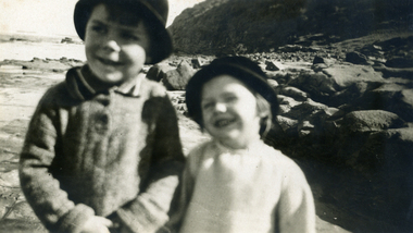 Alwyn and Alison Till, wearing hats. Background sea shore at Phillip Island. 