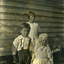 Alwyn Till in front with Alison Till who is dressed in party clothes or dress-ups.