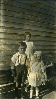 Alwyn Till in front with Alison Till who is dressed in party clothes or dress-ups.