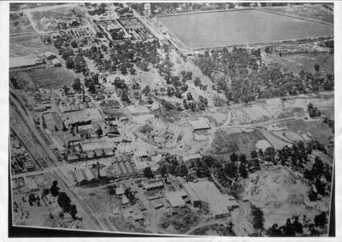 Black and white aerial photograph of Mitcham showing the reservoir, Australian Tesselated Tiles with the clay pit at the rear, and Monarch Tiles (1914-16) in the foreground.