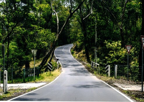 Coloured photograph of Quarry Road, Mitcham looking south. A bridge over Mullum Mullum Creek and the Eastlink Trail appear on the lower section of the photograph - 2012