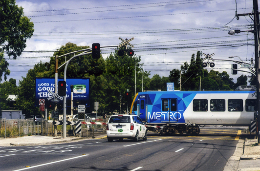 Metro train crossing Mitcham Road and heading east towards Ringwood - 2012. 