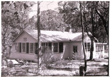 Black and white photograph of the Open Air School, Blackburn showing the building in a bush setting with deck chairs on the left.