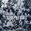 lack and white photograph of the Mitcham Football team and supporters taken outside in1904.