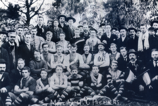 lack and white photograph of the Mitcham Football team and supporters taken outside in1904.