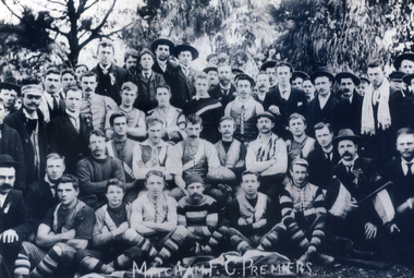 lack and white photograph of the Mitcham Football team and supporters taken outside in1904.