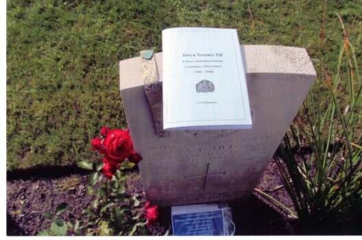 Coloured Photograph of Alwyn Till's grave in a military cemetery in Germany. The booklet on top is the story of Alwyn's service record and was written by Yvonne Fitzmaurice.