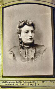 Sepia photograph of a woman with curly fringe