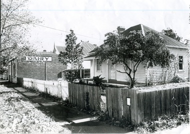 Black and white photograph of the house and dairy