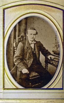 sepia photograph with a framed picture of a man