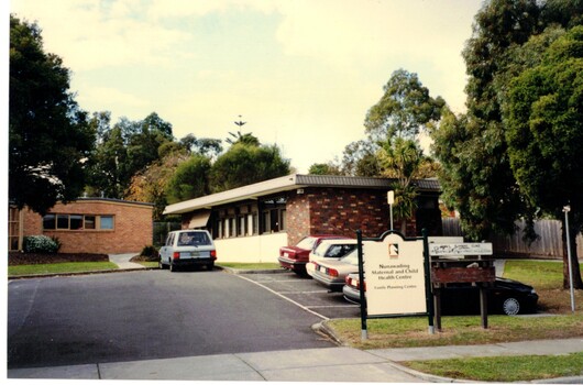 Coloured Photograph of a brick building with a council sign at 