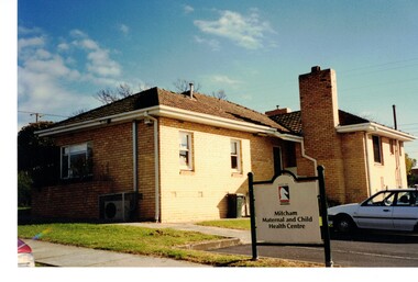 Photograph of a brick building with a council sign at front.