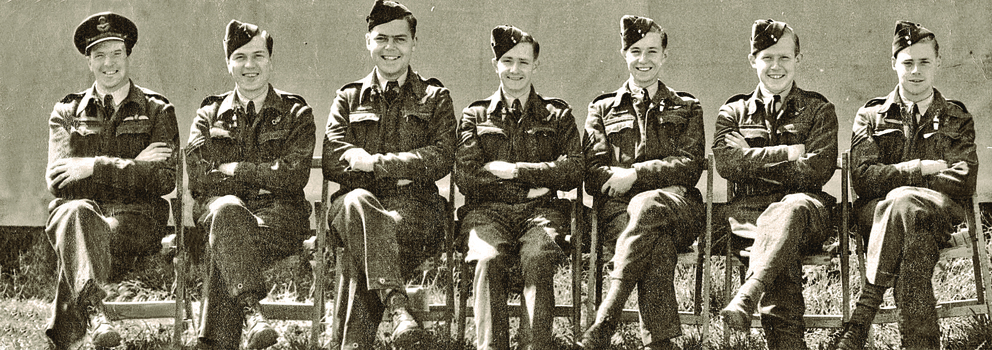 Black and white photograph of 7 airmen seated in uniform.